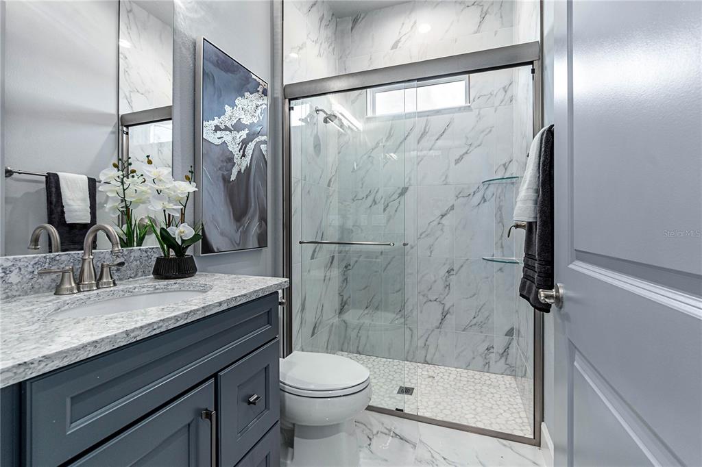 29 Coronado Road Flagler Beach, FL 32136 - Photo 40 of 81 a bathroom with a granite countertop sink toilet and shower