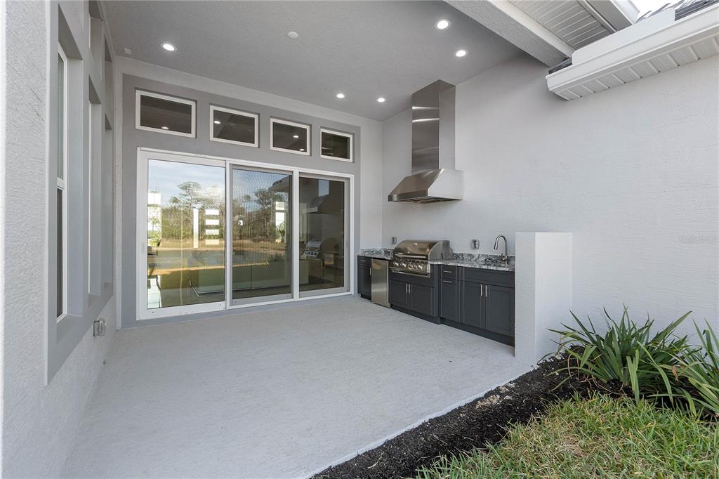 29 Coronado Road Flagler Beach, FL 32136 - Photo 44 of 81 a large kitchen with stainless steel appliances a large counter top a stove and a refrigerator