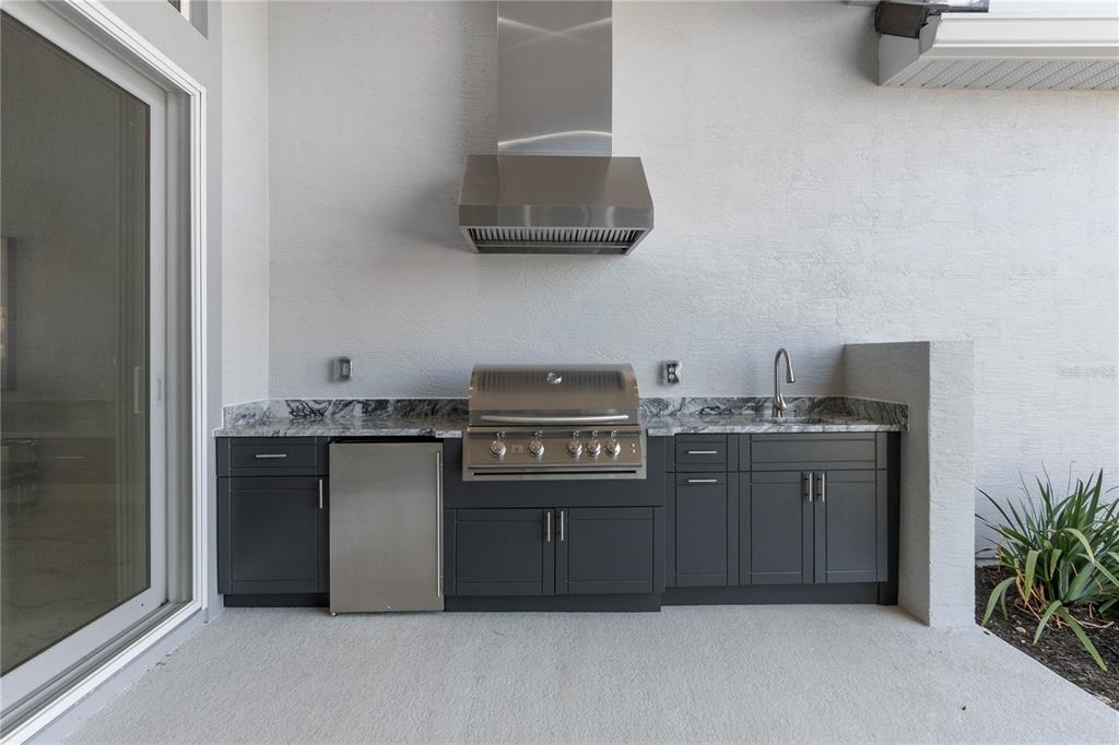 29 Coronado Road Flagler Beach, FL 32136 - Photo 45 of 81 a kitchen with a sink and a stove with wooden floor