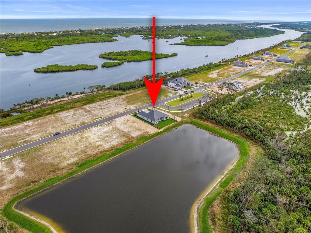29 Coronado Road Flagler Beach, FL 32136 - Photo 56 of 81 a view of a lake with a beach and a yard