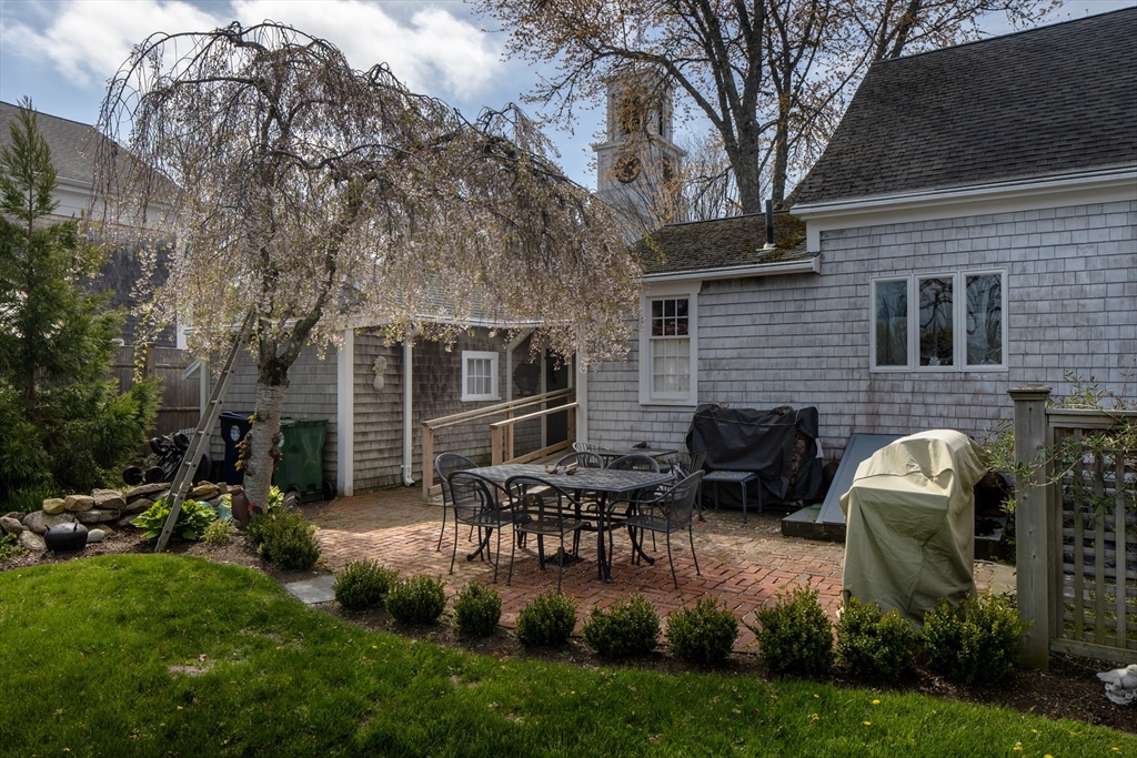 31 Main Street Marion, MA 02738 - Photo 17 of 29 a backyard of a house with table and chairs