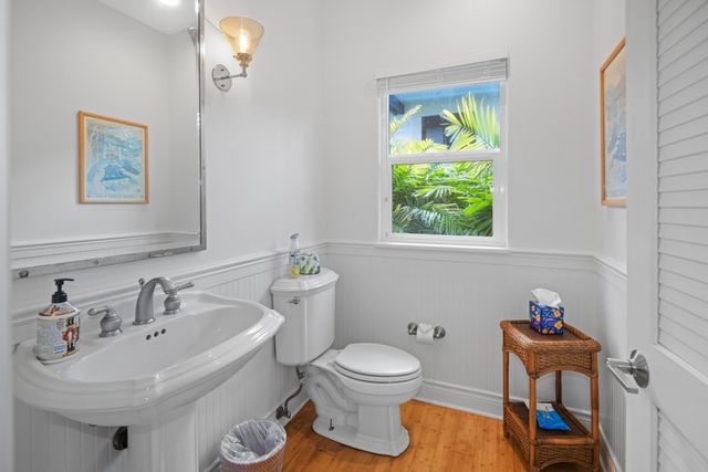 a bathroom with a sink toilet and a window