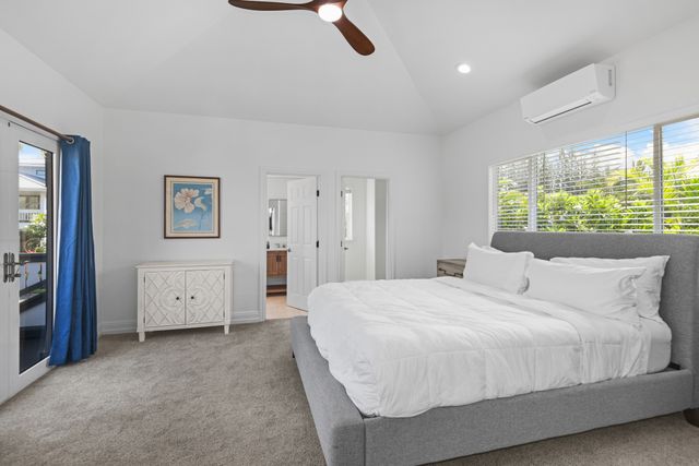 a bedroom with a bed and a large window