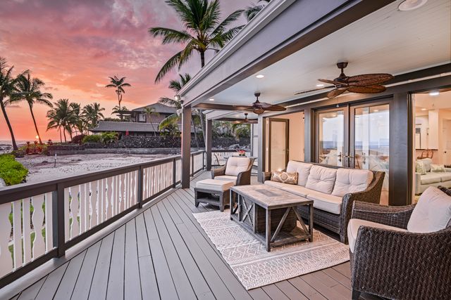 a view of a chair and tables in the balcony