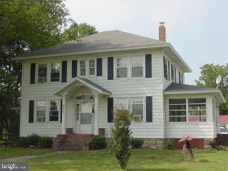 8513 Newark Road Newark, MD 21841 - Photo 1 of 14 a front view of a house with a yard