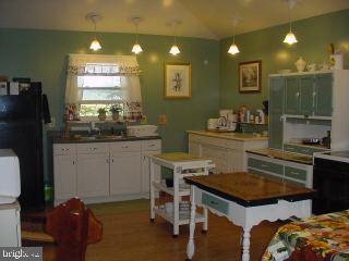 8513 Newark Road Newark, MD 21841 - Photo 5 of 14 a kitchen with a table and chairs in it