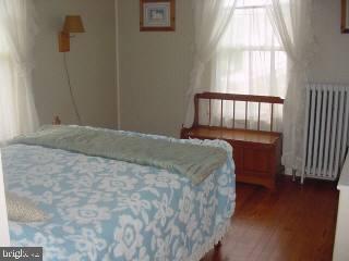 8513 Newark Road Newark, MD 21841 - Photo 10 of 14 a bed sitting in a bedroom next to a window