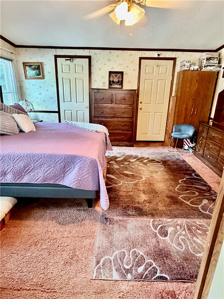 1549 Greenfield Road Westminster, SC 29693 - Photo 26 of 49 Cozy bedroom with textured flooring and convenient ceiling fan for comfort.