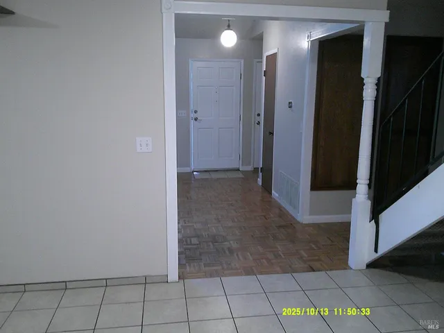 a view of a hallway with closet and a bathroom
