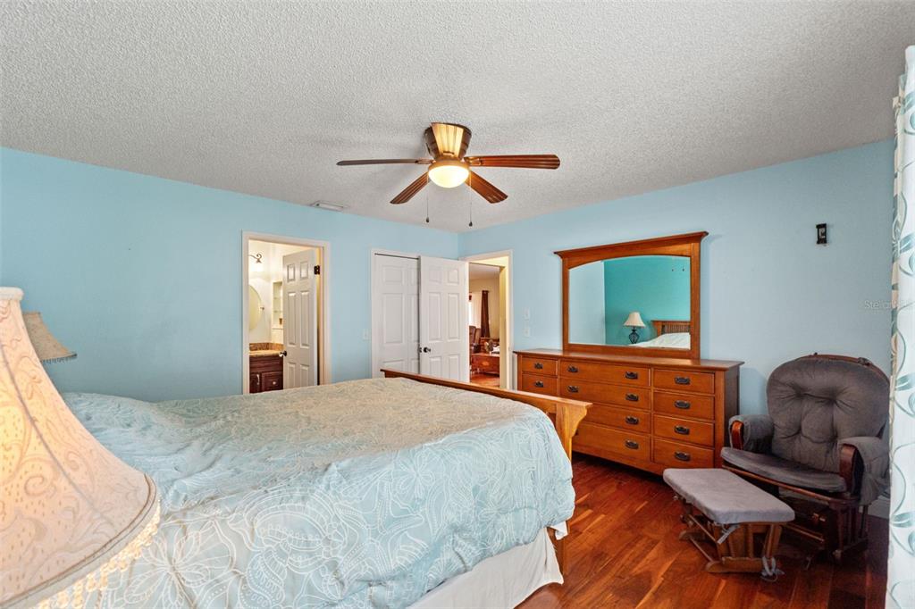 7828 Hardwick Drive, Unit 924 New Port Richey, FL 34653 - Photo 12 of 35 a bedroom with a bed and a chandelier