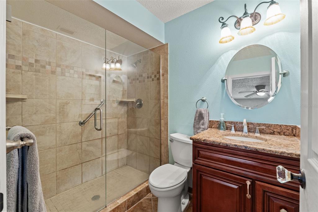 7828 Hardwick Drive, Unit 924 New Port Richey, FL 34653 - Photo 13 of 35 a bathroom with a sink toilet and shower