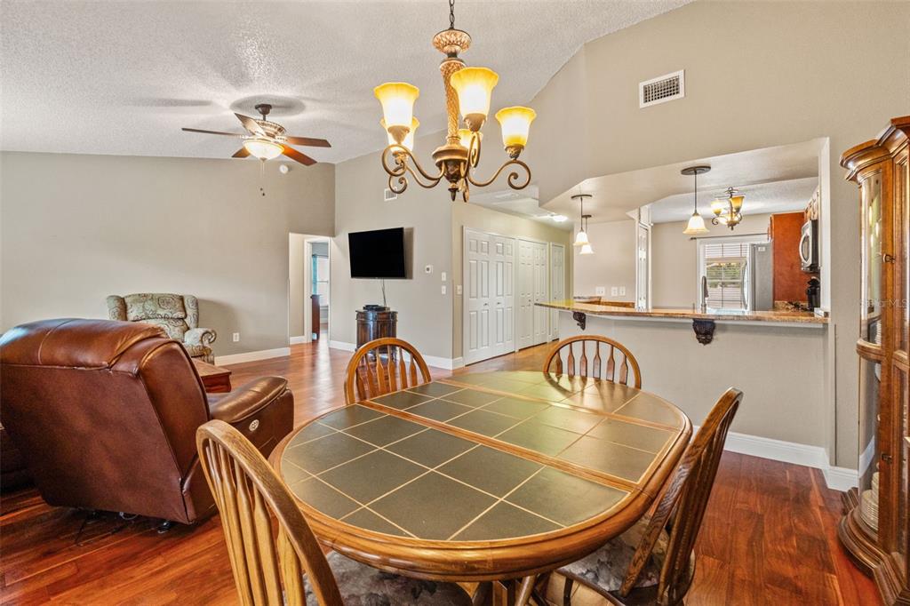 7828 Hardwick Drive, Unit 924 New Port Richey, FL 34653 - Photo 19 of 35 a view of a dining room with furniture and a chandelier