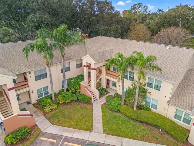 an aerial view of a house with yard and green space