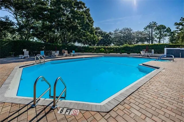a view of a swimming pool with a table and chairs
