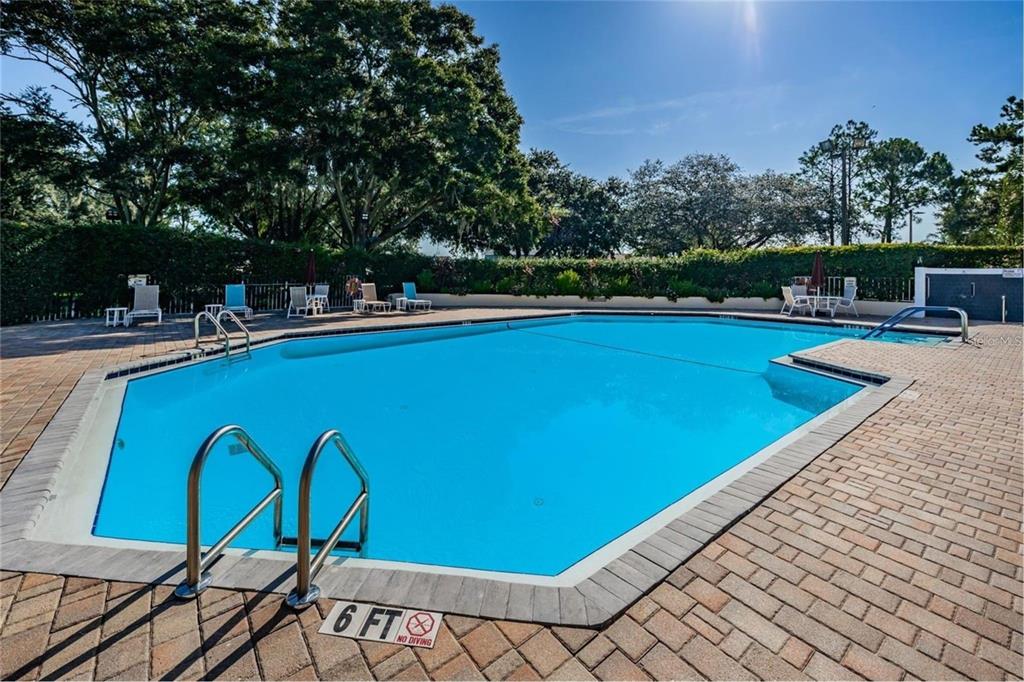 7828 Hardwick Drive, Unit 924 New Port Richey, FL 34653 - Photo 3 of 35 a view of a swimming pool with a table and chairs