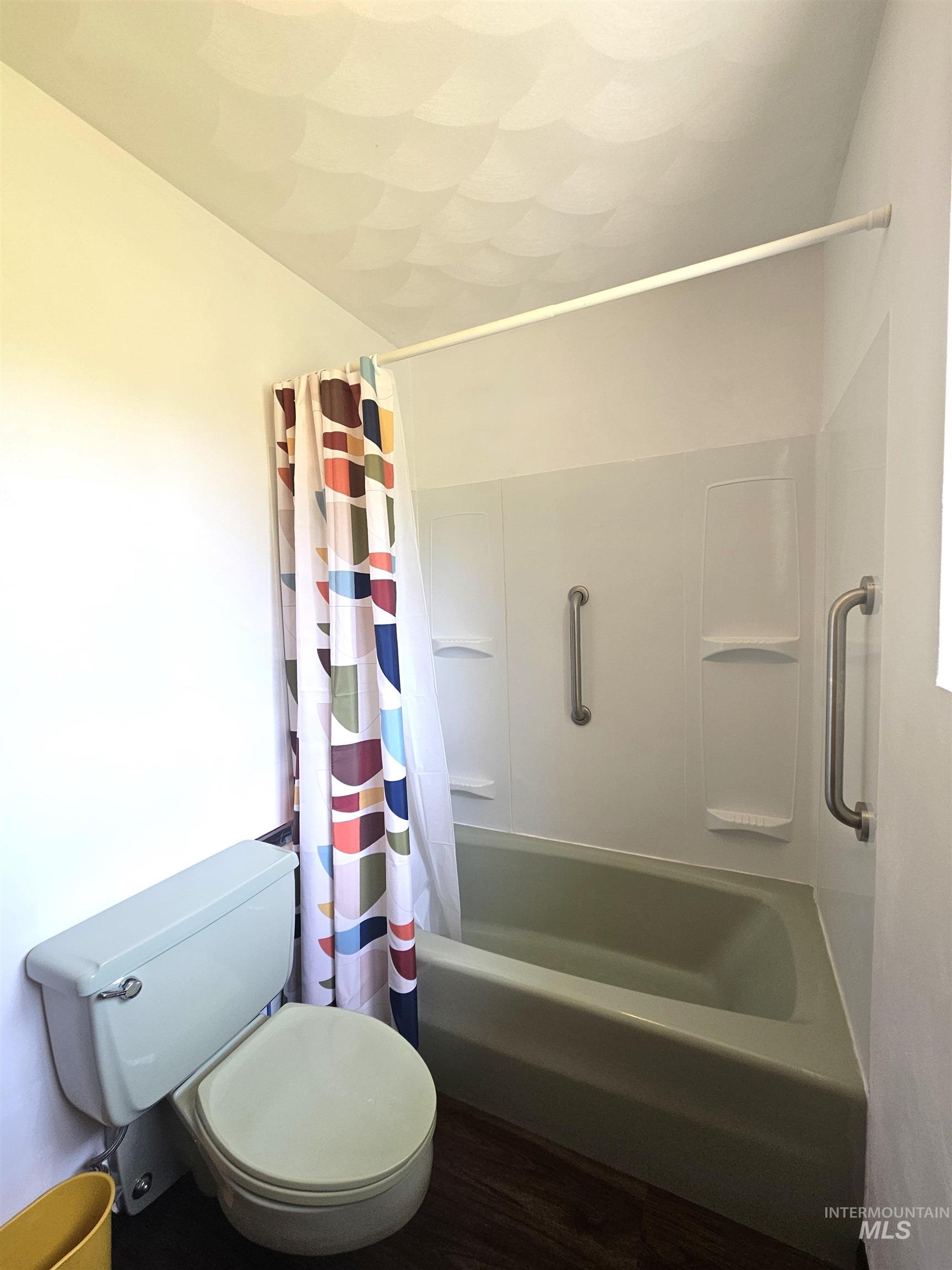 29865 Mission Creek Road Culdesac, ID 83524 - Photo 27 of 43 Bathroom featuring a built-in tub with grab bars, integrated shelving, and a shower curtain rod