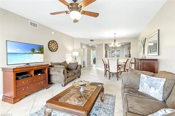 a living room with furniture and a chandelier