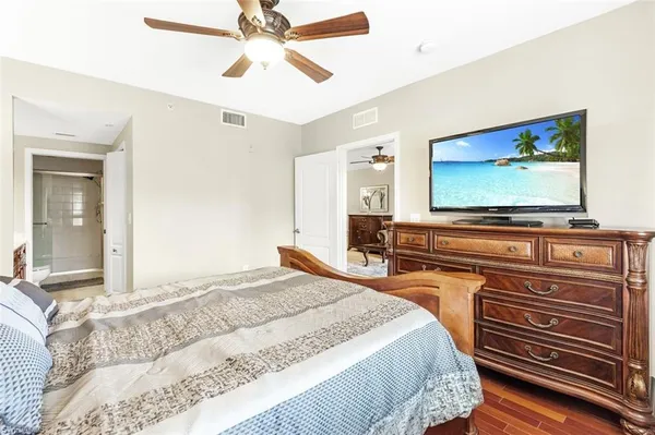 a bedroom with a bed dresser and a window
