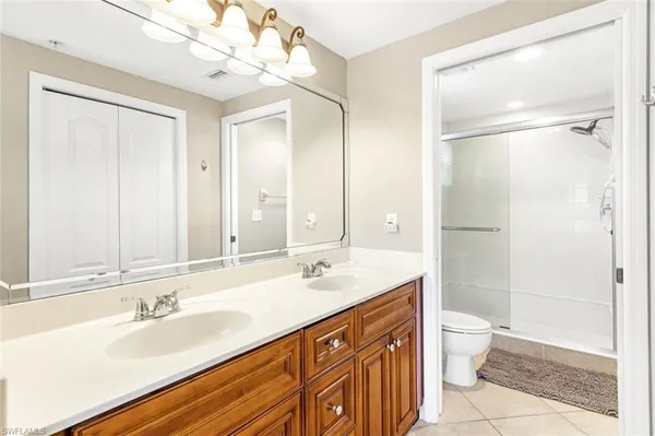 a bathroom with a sink a mirror and a shower