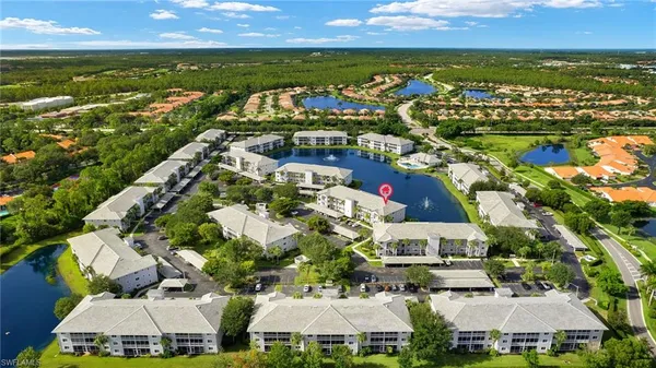 an aerial view of a house with outdoor space pool seating area and yard
