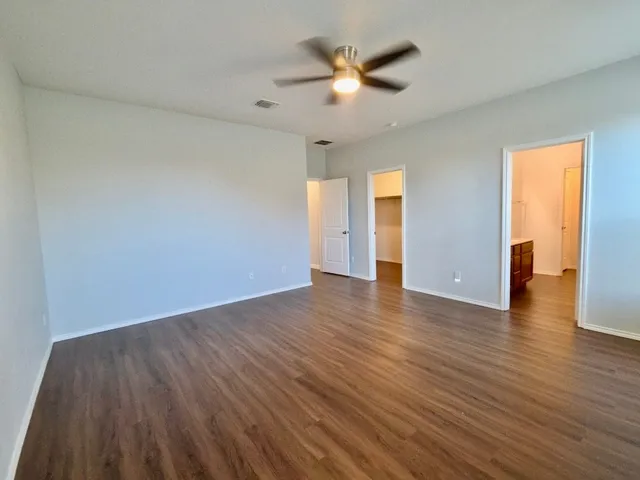 an empty room with wooden floor and closet