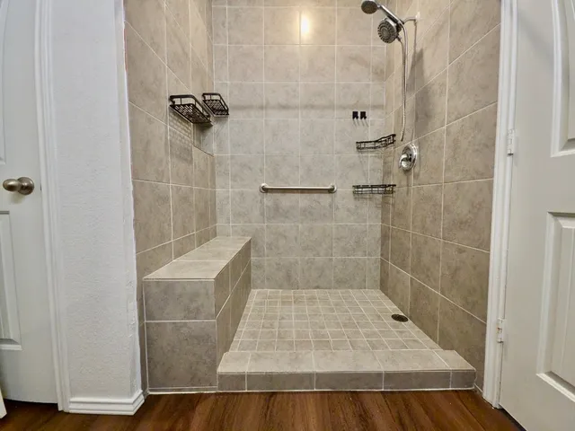 a bathroom with a sink a mirror and shower