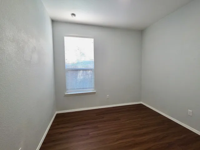 a view of a room with wooden floor