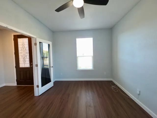 wooden floor in an empty room with a window