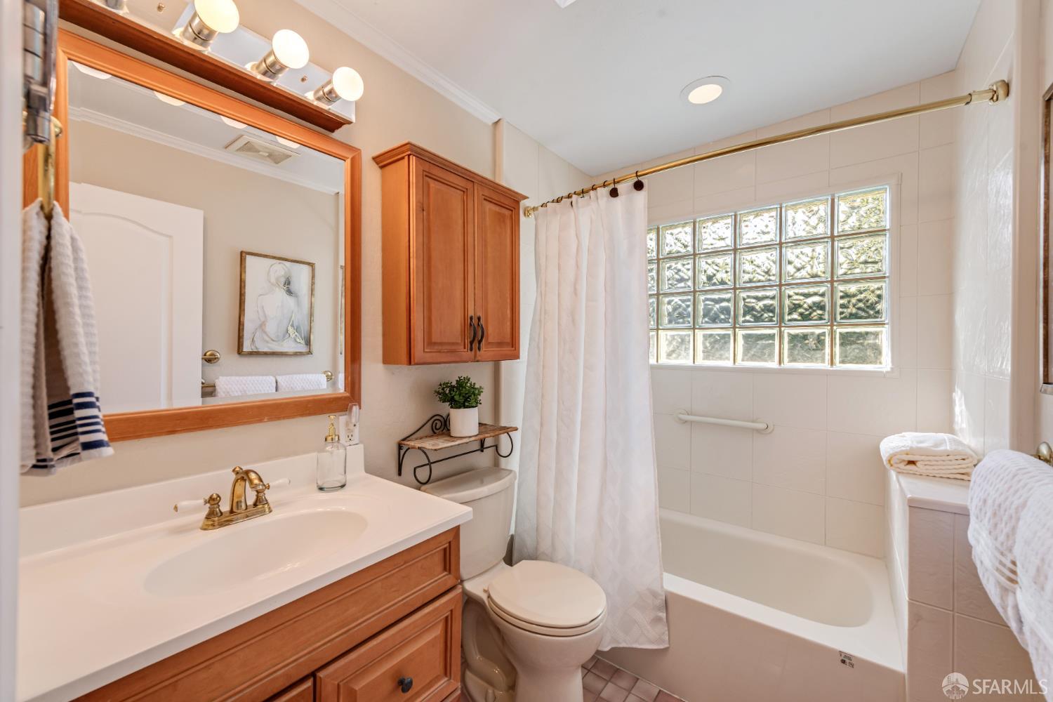 1284 Columbus Street El Granada, CA 94019 - Photo 14 of 15 a bathroom with a sink a toilet and a large mirror