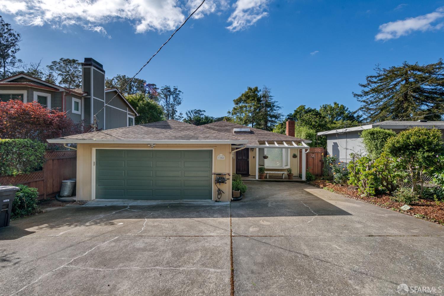 1284 Columbus Street El Granada, CA 94019 - Photo 2 of 15 a front view of a house with a yard and garage