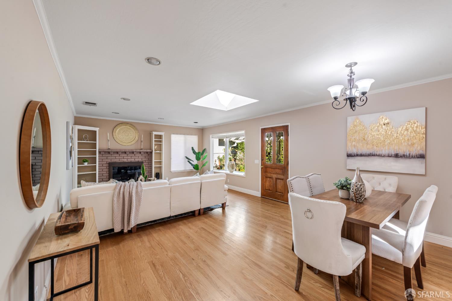 1284 Columbus Street El Granada, CA 94019 - Photo 3 of 15 a living room with furniture a fireplace and a chandelier