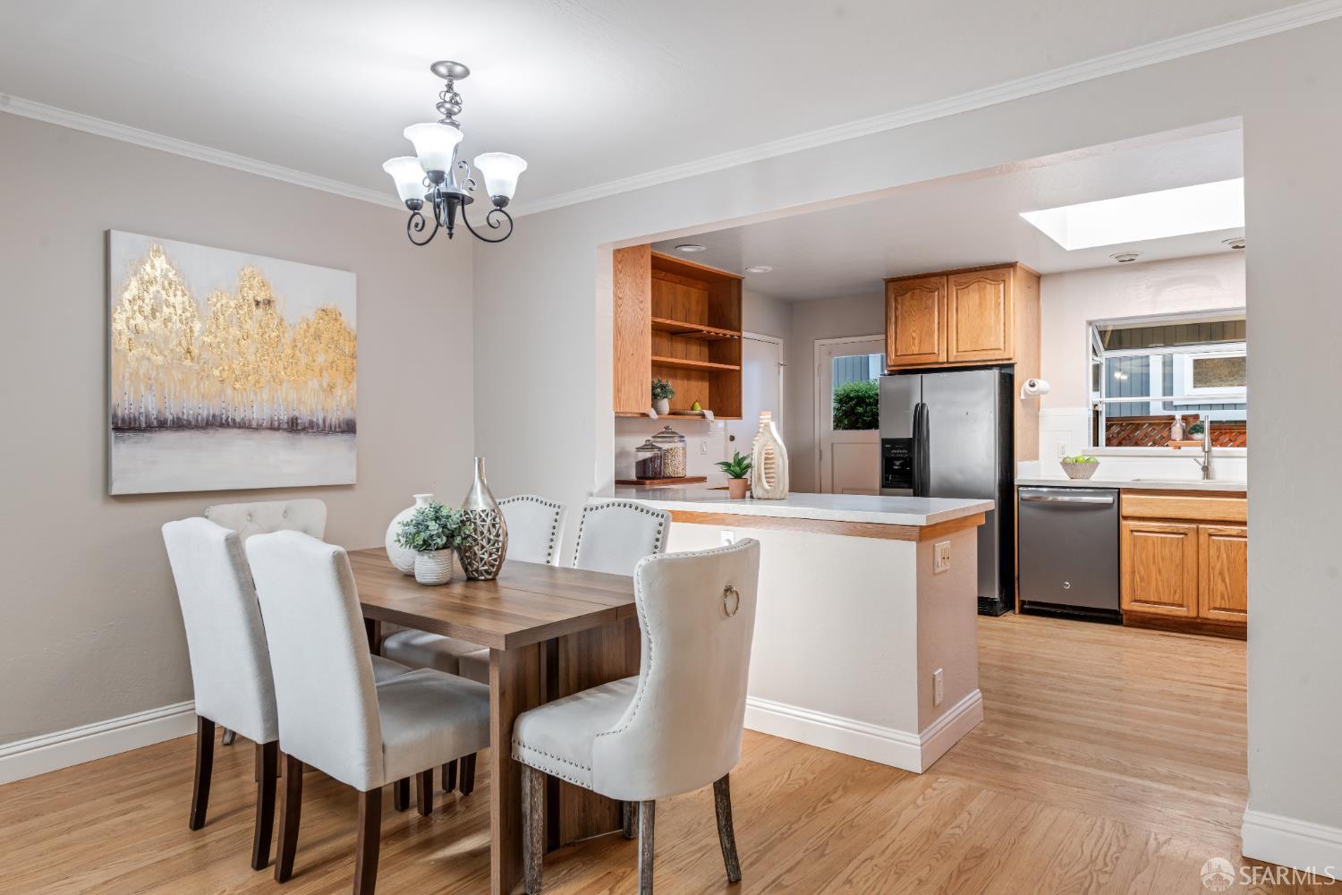 1284 Columbus Street El Granada, CA 94019 - Photo 5 of 15 a kitchen with stainless steel appliances wooden floor and dining table