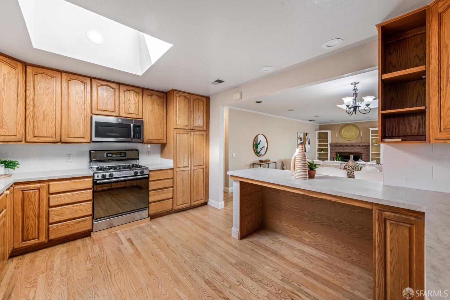1284 Columbus Street El Granada, CA 94019 - Photo 6 of 15 a kitchen with stainless steel appliances granite countertop a stove top oven a sink dishwasher and a refrigerator with wooden floor