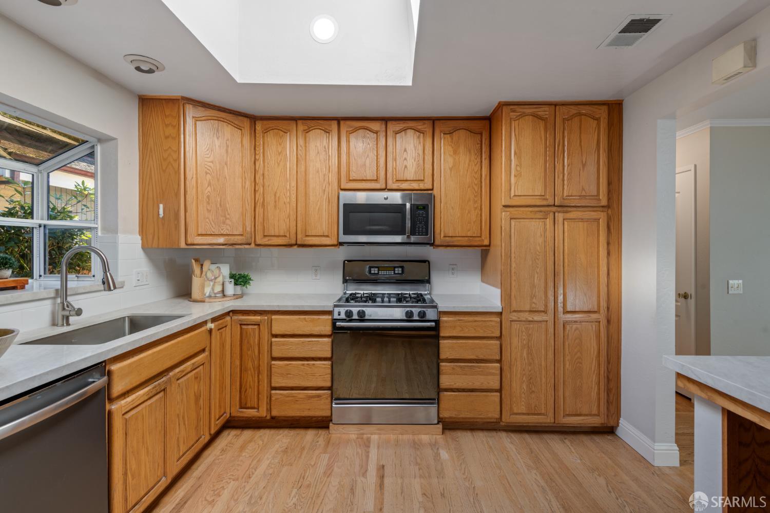 1284 Columbus Street El Granada, CA 94019 - Photo 8 of 15 a kitchen with stainless steel appliances granite countertop a stove refrigerator and cabinets