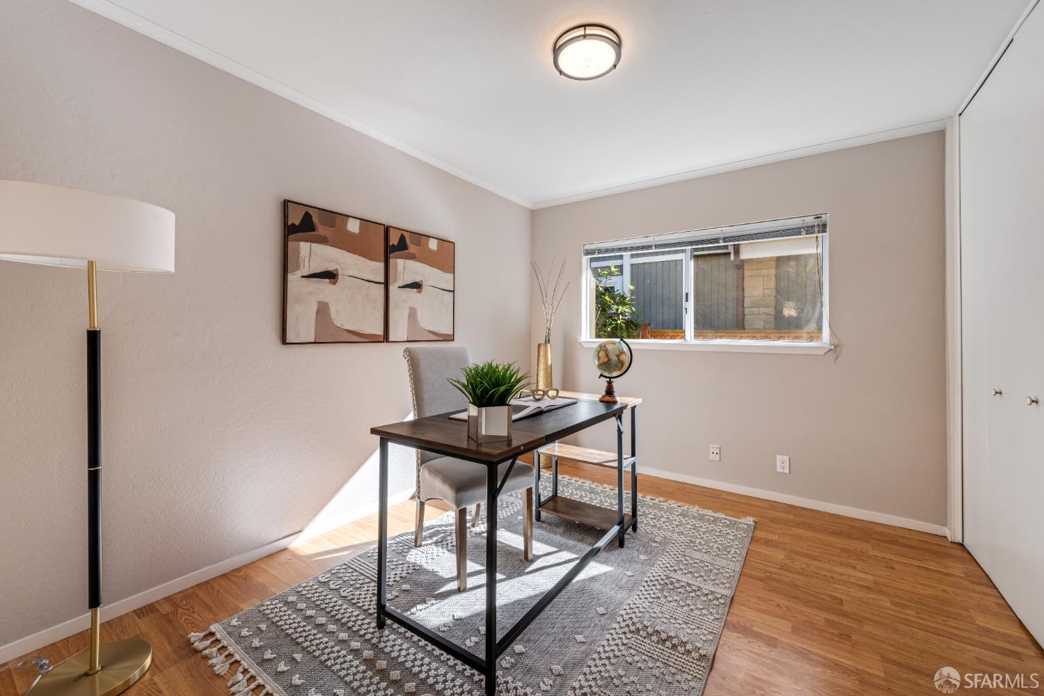 1284 Columbus Street El Granada, CA 94019 - Photo 9 of 15 a view of a workspace room with wooden floor and windows