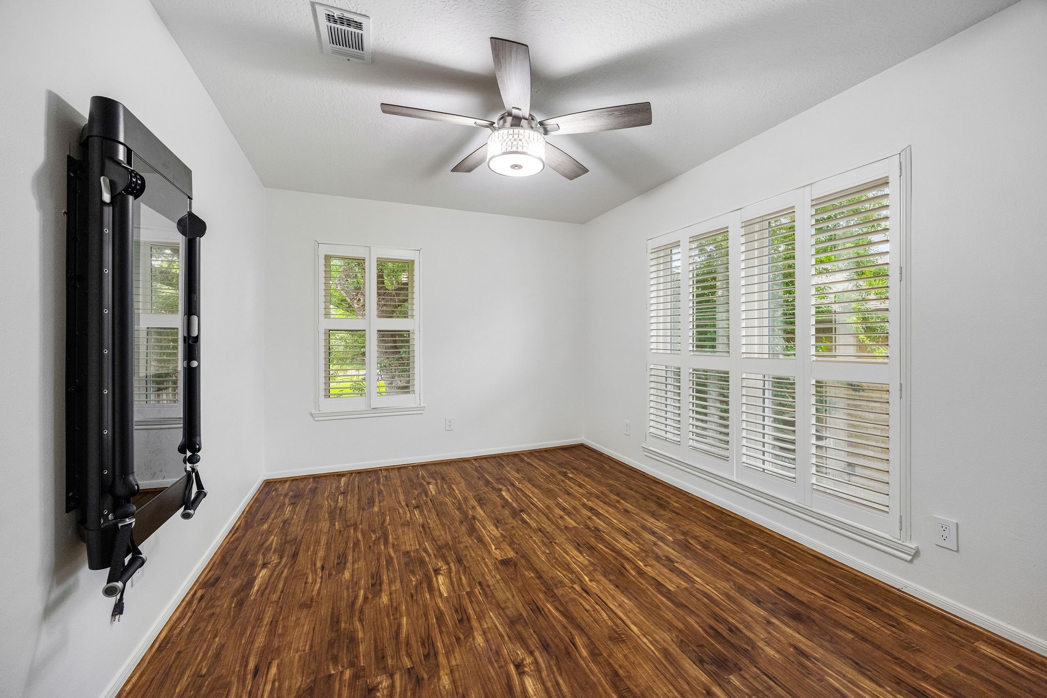 727 Bunker Hill Road, Unit 26 Houston, TX 77024 - Photo 21 of 25 The last of the bedrooms is also located at the front of the house and features an abundance of natural light. It's currently being used as an exercise room and the owners are open to leaving the fitness mirror for the tenants.