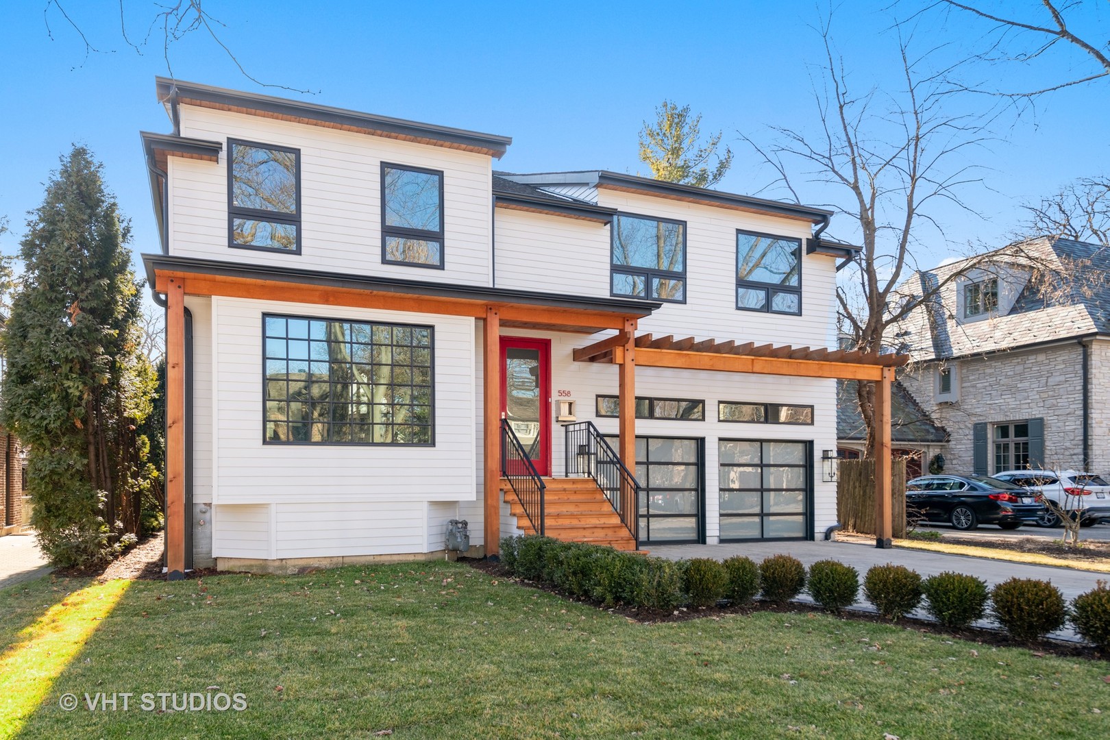 558 Willow Road Winnetka, IL 60093 - Photo 2 of 43 a front view of a house with a yard