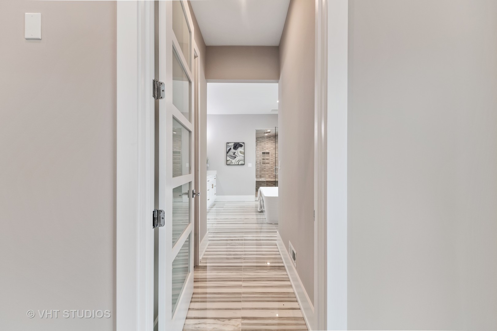 558 Willow Road Winnetka, IL 60093 - Photo 20 of 43 a view of a hallway with a livingroom and a bathroom with sink
