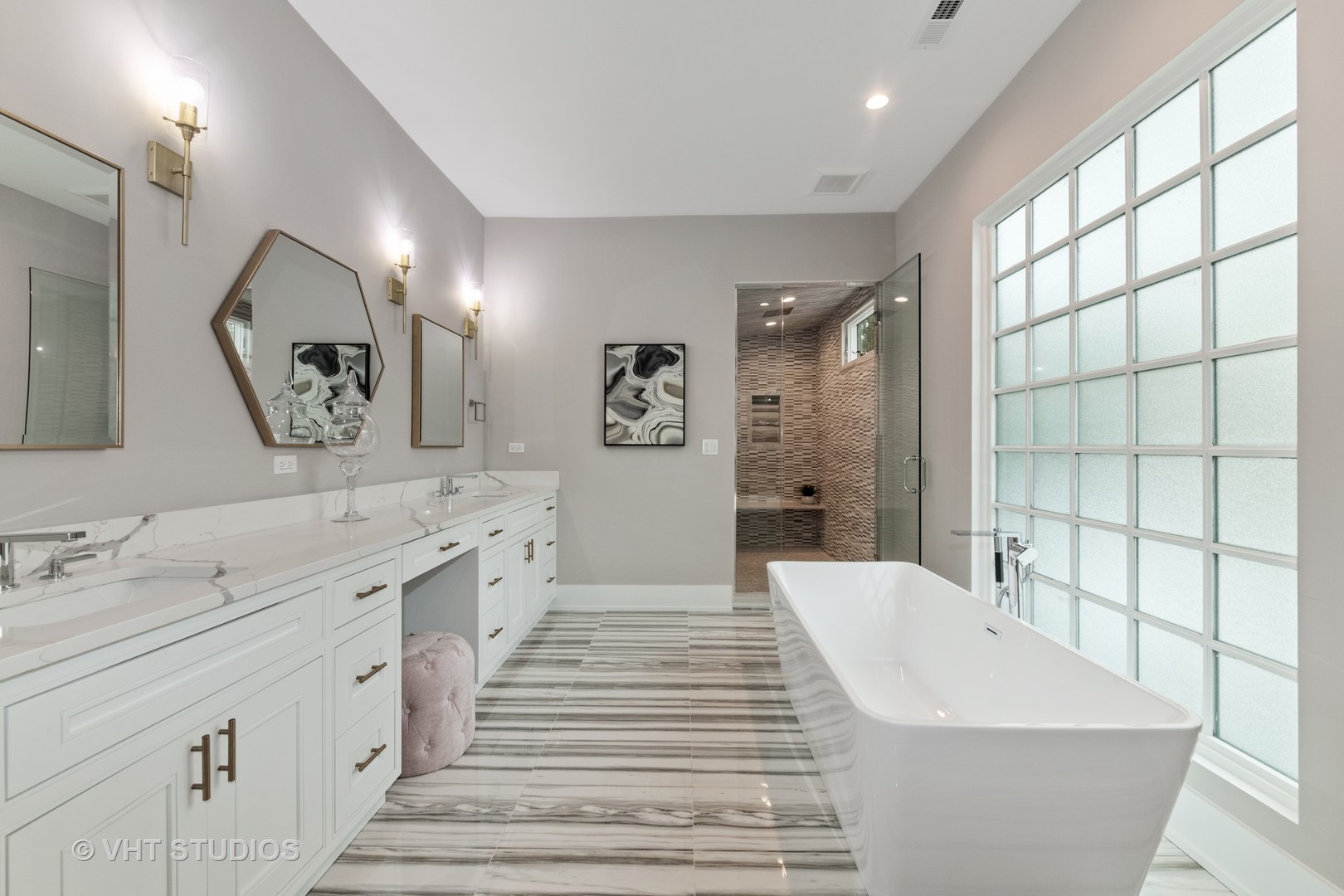 558 Willow Road Winnetka, IL 60093 - Photo 22 of 43 a spacious bathroom with double vanity sinks a large mirror and a bathtub