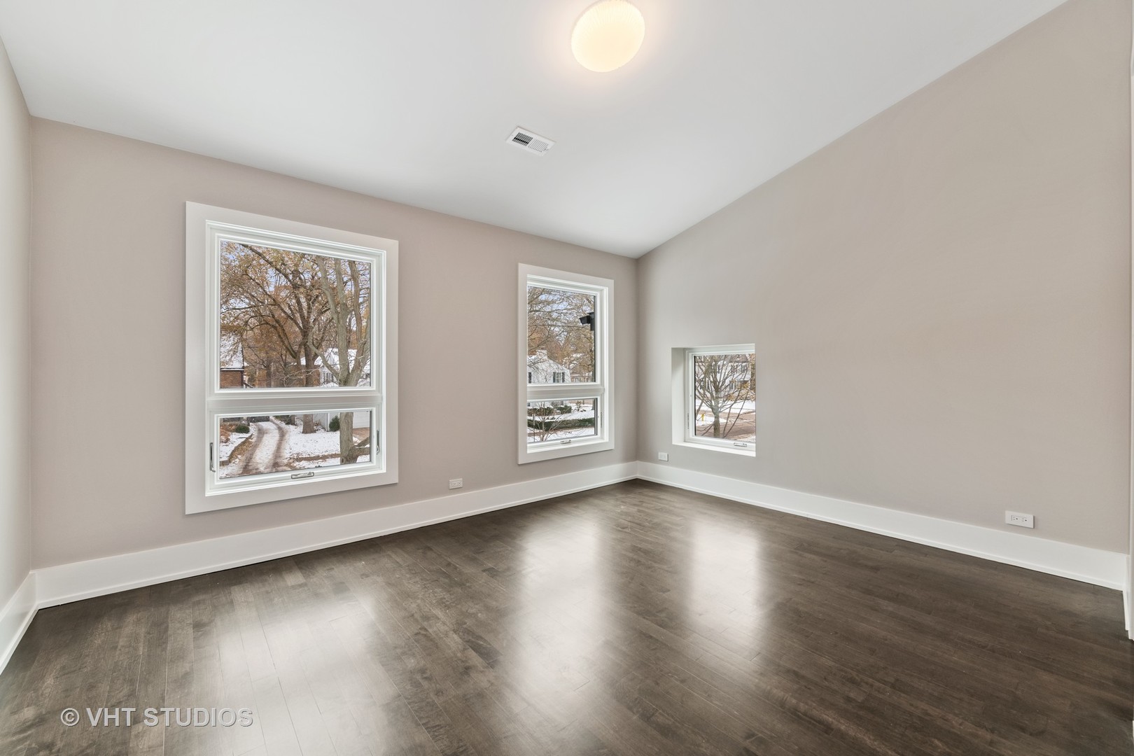 558 Willow Road Winnetka, IL 60093 - Photo 24 of 43 a view of an empty room with wooden floor and window
