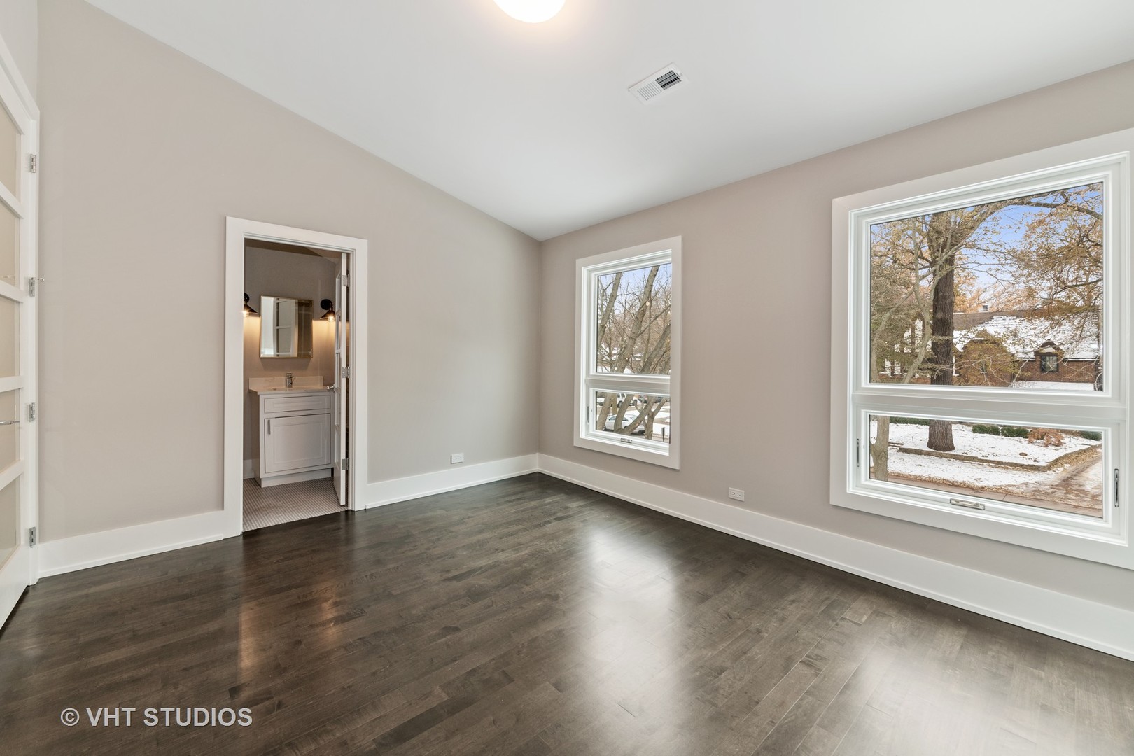 558 Willow Road Winnetka, IL 60093 - Photo 25 of 43 a view of an empty room with wooden floor and a window