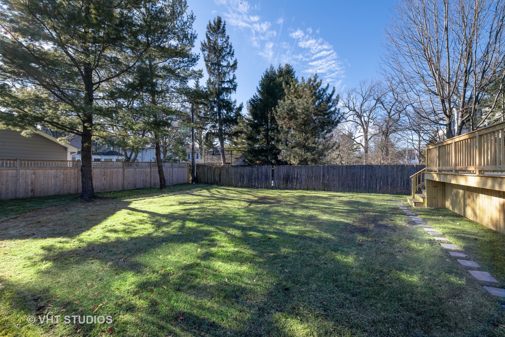 558 Willow Road Winnetka, IL 60093 - Photo 39 of 43 a view of a backyard with large tree and wooden fence