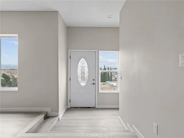 a view of a room with wooden floor and window
