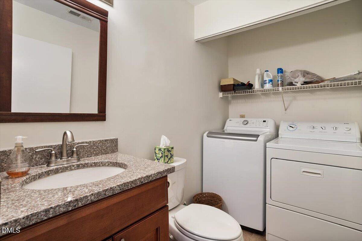 163 Springberry Lane Chapel Hill, NC 27517 - Photo 13 of 32 a bathroom with a granite countertop toilet sink and mirror