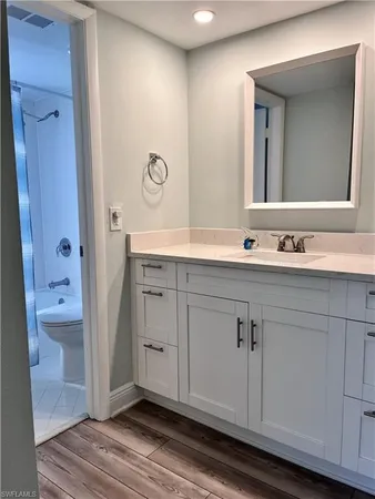 a spacious bathroom with a double vanity sink a mirror and a bathtub