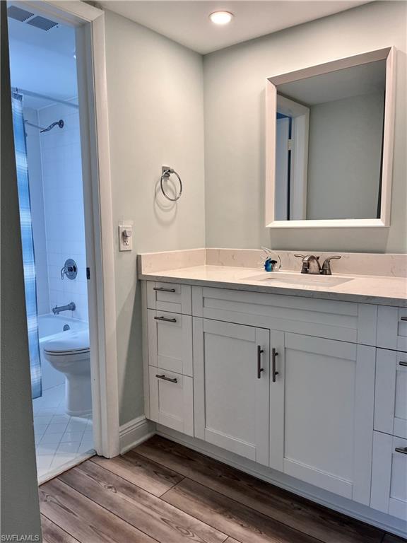 202 Peppermint Lane, Unit 2 Naples, FL 34112 - Photo 13 of 23 a spacious bathroom with a double vanity sink a mirror and a bathtub
