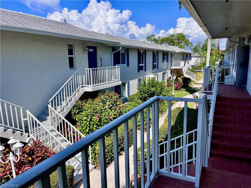 202 Peppermint Lane, Unit 2 Naples, FL 34112 - Photo 14 of 23 a view of a house with wooden deck and furniture