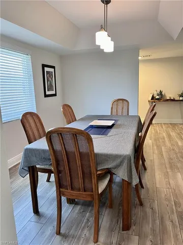 a view of a dining room with furniture wooden floor and chandelier