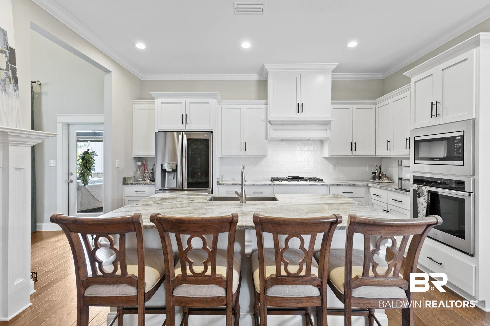 291 Hemlock Drive Fairhope, AL 36532 - Photo 16 of 65 Kitchen featuring white cabinetry, stainless steel appliances, an island with sink, light stone countertops, and recessed lighting