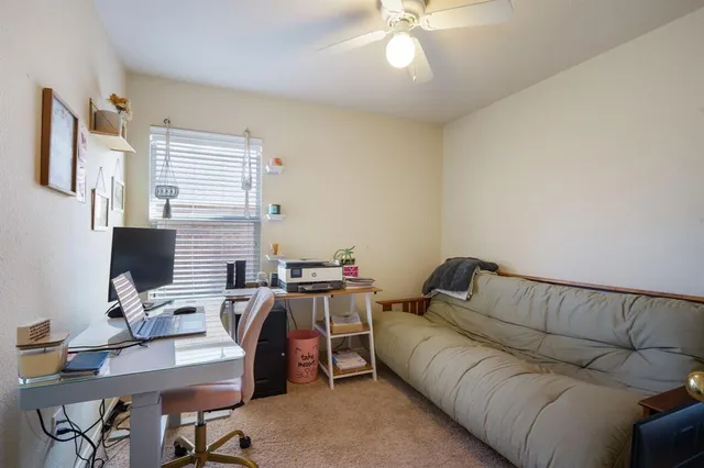 a living room with furniture and two window
